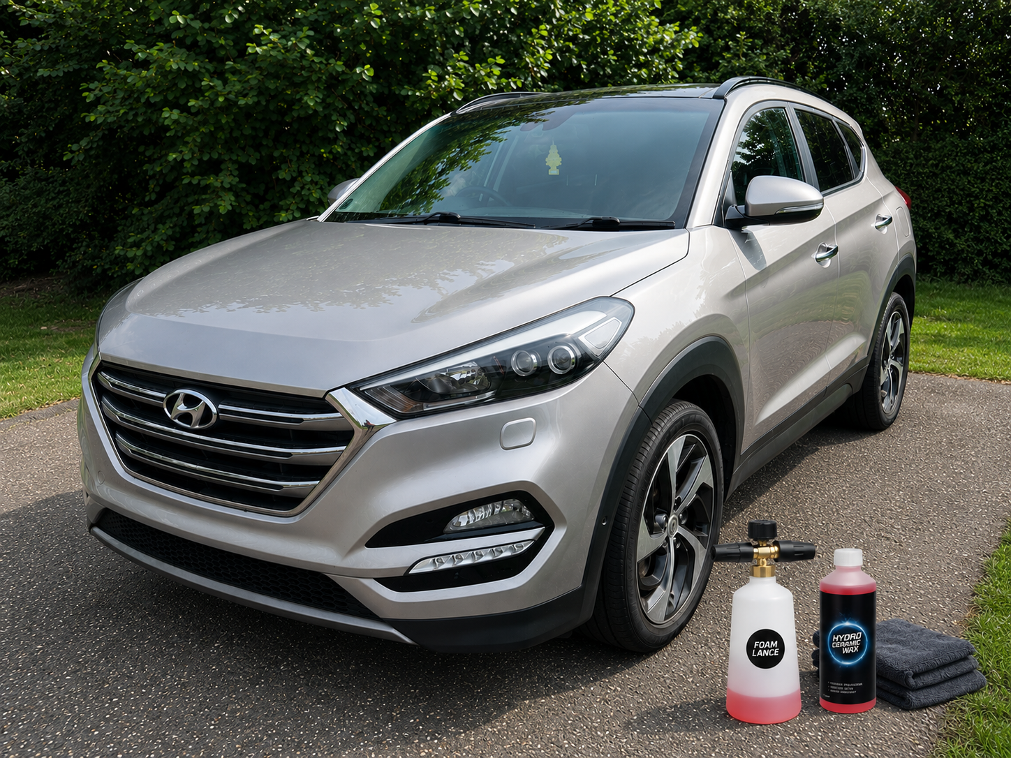 Nerta Hydro Ceramic Wax concentrate with foam lance and microfibre cloth beside vehicle ready for ceramic protection treatment